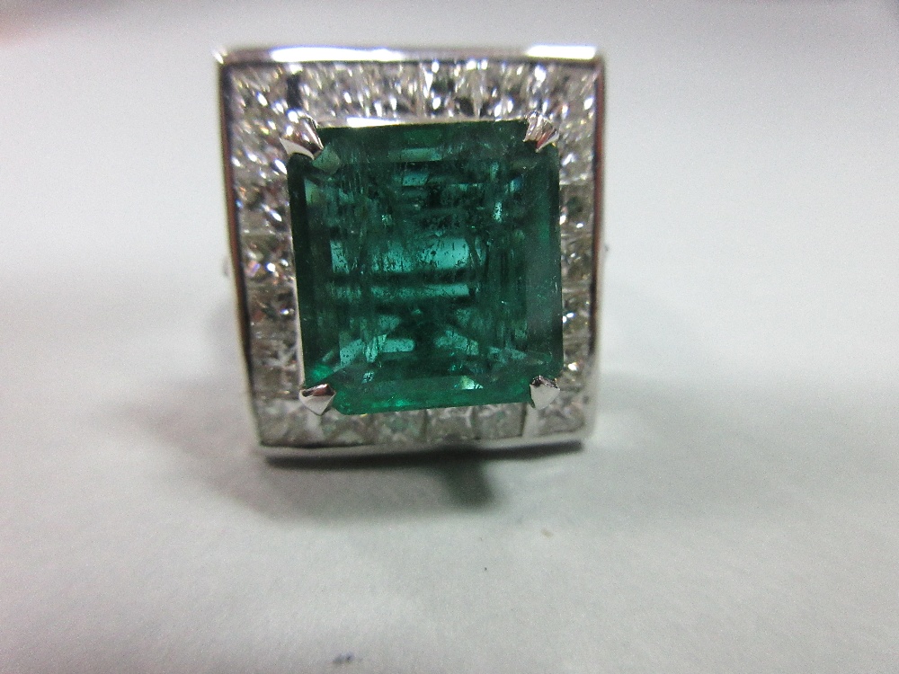 A large emerald and diamond cluster ring, the emerald cut emerald, estimated weight 4.78cts, above a - Image 8 of 8