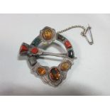 A mid-Victorian Scottish agate and cairngorm plaid brooch, of penannular form crossed by a dirk, set