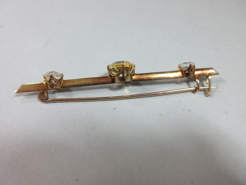 A yellow sapphire and white sapphire bar brooch, claw set to the centre of the knife-edge bar with - Image 3 of 6