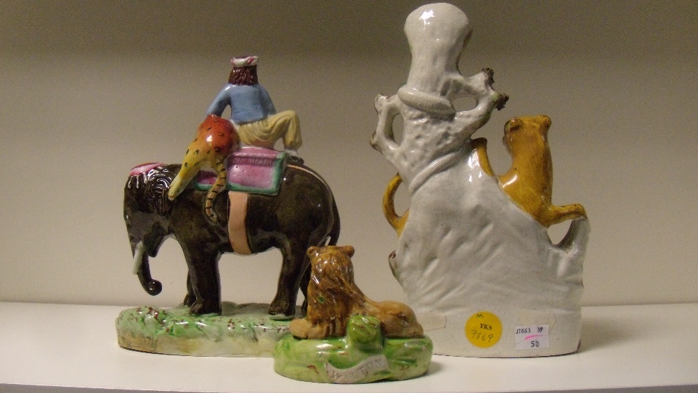 Three 19th century Staffordshire pottery figures, the 'Walton' lion reclining on a green mound, - Image 3 of 4