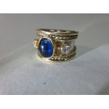A diamond, sapphire, platinum and gold ring in the manner of Elizabeth Gage or Cassandra Goad,