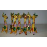Seven Soviet colourful giraffe figurines, 25.5cm high (7)