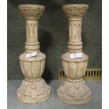 A pair of carved wooden cream painted candlesticks, 31cm