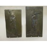 Two gilt bronze plaques, relief-decorated with warriors