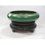 A Chinese cloisonne green enamel bowl on stand