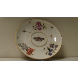 An 18th century Meissen ecuelle stand, the central butterfly painted within scattered flowers and