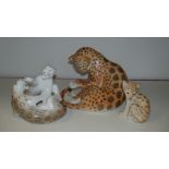 Three Lomonosov leopard groups, the largest playing with its tail, 19cm, the pair playing and