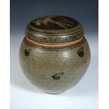 A studio pottery jar and cover, possibly by Andrew Hague, the stoneware body decorated in iron