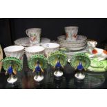 Decorative china to include Dresden cups and saucers, four peacock menu holders, etc.