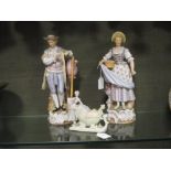 A pair of late 19th century German porcelain figures of a gentleman and wife in 18th century dress