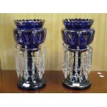 A pair of blue glass and gilt decorated lustres, 35cm high