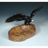 A patinated bronze model of an eagle, mounted to a marble ashtray base, together with a gilt