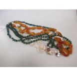 An amber bead necklace, a pearl and rock crystal necklace, a malachite bead necklace and a green