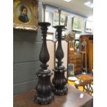 A pair of carved mahogany table lamps, 91 cm high