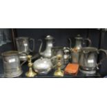 A collection of antique pewter quart mugs or measures and other items