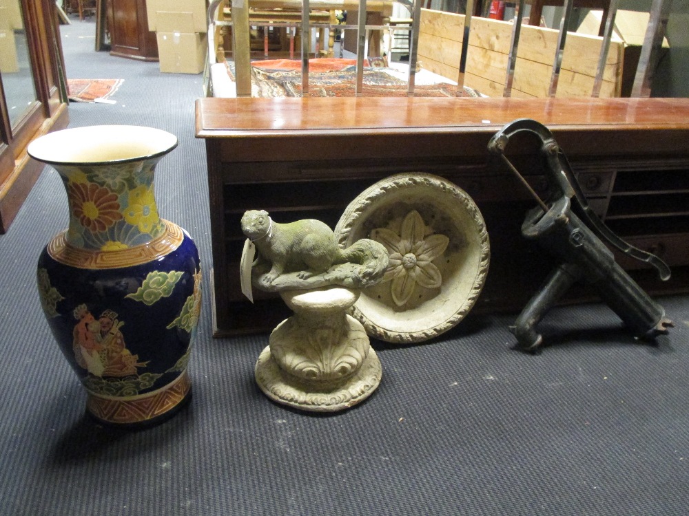 A reconstituted stone bird bath, garden squirrel ornament, cast iron waterpump and a vase (4)