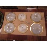 Four and two circular brass ceiling lights