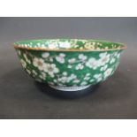 A Japanese bowl with a green blossom ground