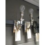 A pair of chrome wall lights