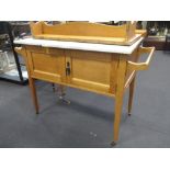 An Edwardian light oak marble top washstand with tiled gallery back and a Regency mahogany bar