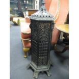 A 'cathedral' type cast iron hexagonal stove with cover, 85 cm high