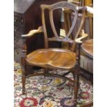 A 19th century country walnut open armchair on turned legs and crinoline stretcher, with scroll