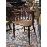 A 19th century elm and ash windsor armchair with a crinoline stretcher and turned legs.