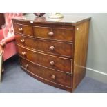 A George III mahogany bow fronted chest containing two short over three long drawers, on cut down