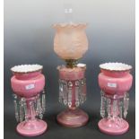 A pink glass and gilt decorated oil lamp (50cm high) together with a pair of pink glass and gilt