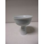 A Ming style blanc de Chine stem cup, the bowl incised with anhua wavy vine of leaves, 9cm (3.5