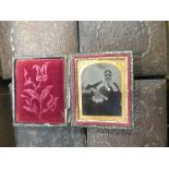 A collection of cased ambrotype photographs