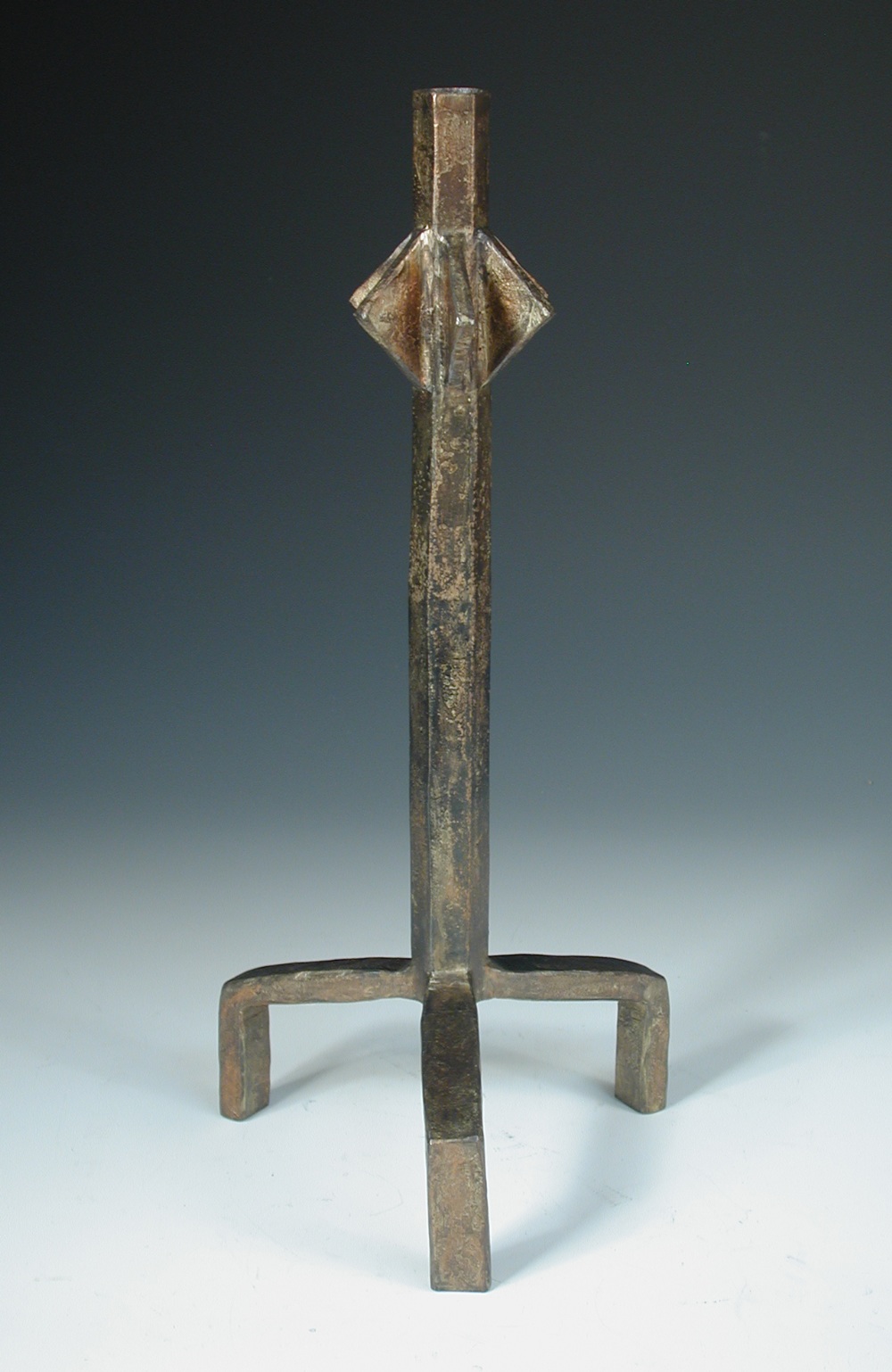 A patinated bronze candlestick, cast after a design by Diego Giacometti, signed to base 38½cm (15in)