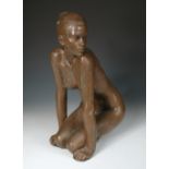 A modern bronzed resinous model of a female kneeling nude, indistinctly signed and dated (19)82,