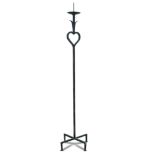 Jean Royere, (1902-1981), a wrought-iron pricket candle stick, with heart motif, raised on a
