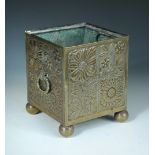 An Arts & Crafts brass square planter in the manner of Christopher Dresser, embossed with floral