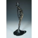 An Art Nouveau bronze candlestick, the female nude supporting a scone above her head, raised on a