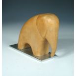 A Hagenauer stylised model of an elephant, the carved wood figure mounted on a rectangular aluminium
