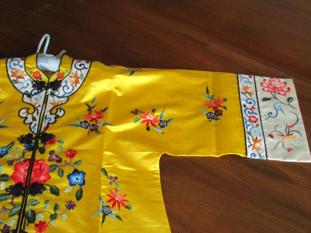 A Chinese lady's silk yellow ground robe embroidered with coloured flowers, the length from collar - Image 3 of 4