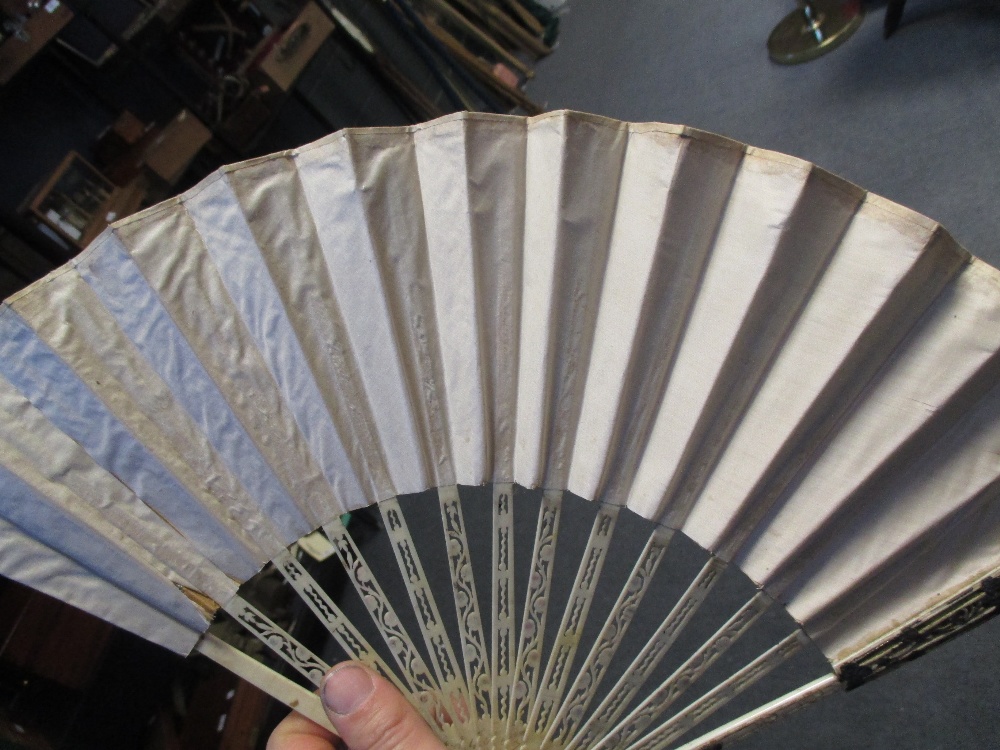 A late 18th century bone and white metal inlaid fan painted with classical scenes and various - Image 4 of 4
