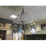 An 18 branch wrought iron chandelier of bell outline