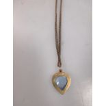 A pale blue hardstone heart shaped pendant, the faceted blue hardstone in a rubover setting