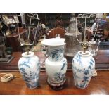 A pair of modern Delft blue and white vases/lamps together with a Chinese blue and white vase with