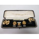 A 9ct gentlemans dress set to include a pair of cufflinks, collar studs and dress studs (one