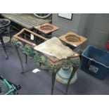 An early 20th century cast iron marble top table, a cast iron pub table and two cast iron table