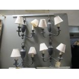 A set of four two branch blacka nd gold wall lights with shades (4)