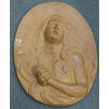 An oval terracotta plaque of the penitent Magdeline, 57cm high