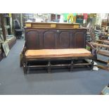 An 18th century oak four panel back settle, 183cm wide