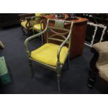 A pair of George III style green painted elbow chairs