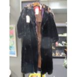 A lady's full length fur coat and a brown leather full length coat (2)