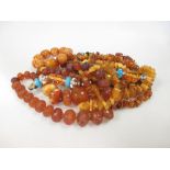 An amber necklace and three amber chip necklaces, together with a group of amber simulant bead